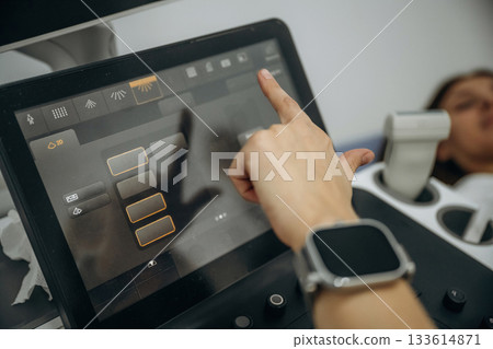 Pregnant woman undergoing ultrasound test 133614871
