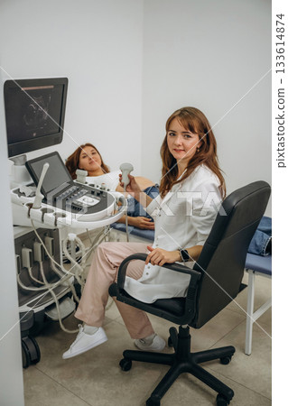 Pregnant woman undergoing ultrasound test 133614874
