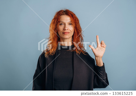 Showing the letter. Woman is in the studio against background 133615225