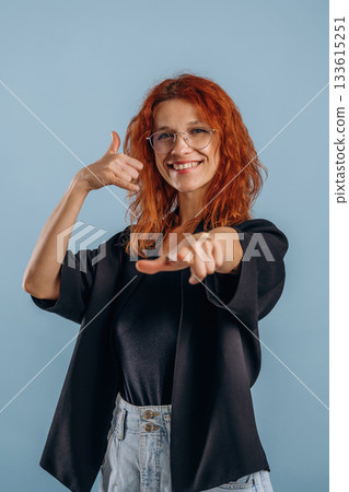 Calling you. Hands gestures. Woman is in the studio against background Calling you. Hands gestures. Woman is in the studio against background 133615251