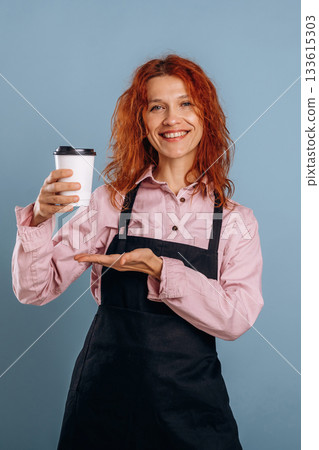Fresh drink in white paper cup. Woman is in the studio against background Fresh drink in white paper cup. Woman is in the studio against background 133615303