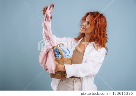 Clothes are not dirty anymore, washed. Woman is in the studio against background 133615350