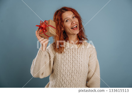 Christmas presents. Woman is in the studio against background Christmas presents. Woman is in the studio against background 133615513