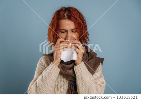 Unhealthy, feeling sick. Woman is in the studio against background 133615521