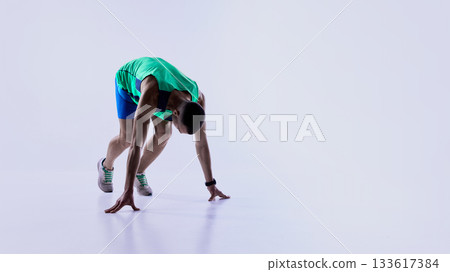 Runner accelerating into fast forward stride Runner accelerating into fast forward stride 133617384