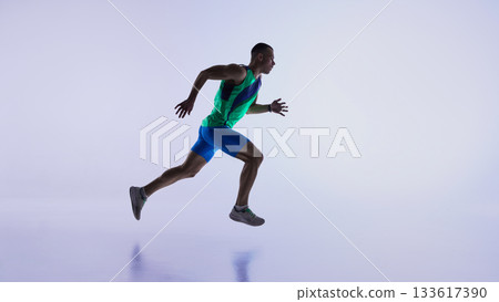 Runner captured mid-air stride during dynamic sprint. 133617390