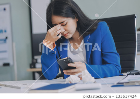 Business woman having headache at office 133617424