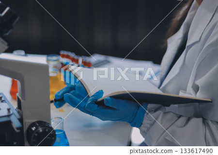 Portrait, science and happy woman on laptop in lab to research chemistry, test or innovation. Microscope, scientist and face of medical doctor in goggles for microbiology, healthcare or pharma study Portrait, science and happy woman on laptop in lab to research chemistry, test or innovation. Microscope, scientist and face of medical doctor in goggles for microbiology, healthcare or pharma study 133617490