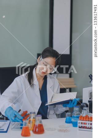 Portrait, science and happy woman on laptop in lab to research chemistry, test or innovation. Microscope, scientist and face of medical doctor in goggles for microbiology, healthcare or pharma study Portrait, science and happy woman on laptop in lab to research chemistry, test or innovation. Microscope, scientist and face of medical doctor in goggles for microbiology, healthcare or pharma study 133617491