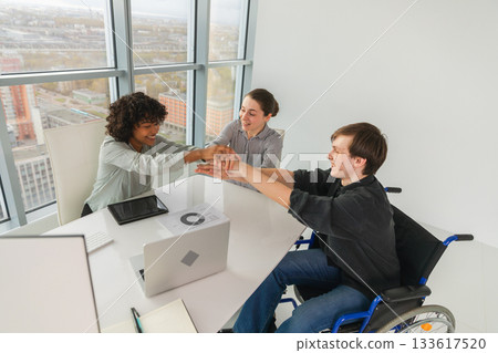 Stack of hands. Business startup teamwork unity concept. Top view of diverse multiracial business people putting hands together. Business colleagues during work process rejoice in success of company Stack of hands. Business startup teamwork unity concept. Top view of diverse multiracial business people putting hands together. Business colleagues during work process rejoice in success of company 133617520