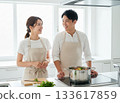 Smiling couple cooking scene 133617859