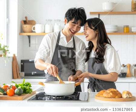 Couple enjoying cooking Couple enjoying cooking 133617865