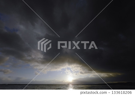 Dark clouds covering the evening sky and the harbor. Spring. Ultra-wide angle. Sky-focused. 240320pm. 133618206