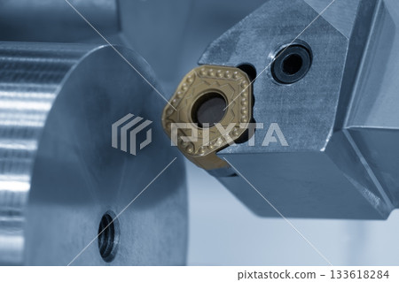 Close up scene the chip insert tool for CNC lathe machine in the light blue scene. Close up scene the chip insert tool for CNC lathe machine in the light blue scene. 133618284