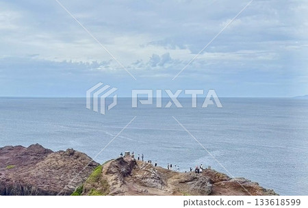 A landscape of rocks jutting out into the sea and the horizon A landscape of rocks jutting out into the sea and the horizon 133618599