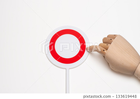 Hand mannequin index finger pointing at a round placard Hand mannequin index finger pointing at a round placard 133619448
