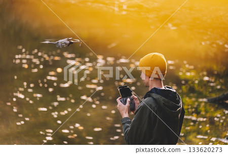 Man Operating Drone Using Remote Controller Man Operating Drone Using Remote Controller 133620273