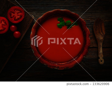 Tomato sauce on clay dish and dark wood 133620906