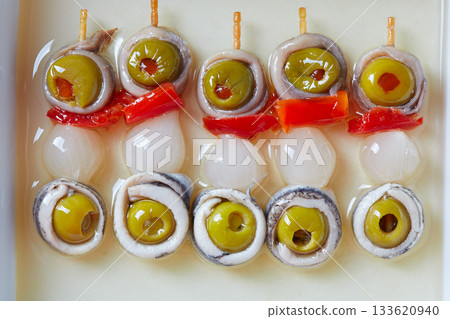 Olives anchovies and pickled onion pinchos Olives anchovies and pickled onion pinchos 133620940