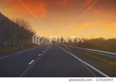 Sunset on the road with golden sky Sunset on the road with golden sky 133620947