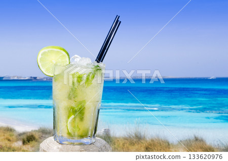 Cocktail mojito ice lemon straws in tropical beach Cocktail mojito ice lemon straws in tropical beach 133620976