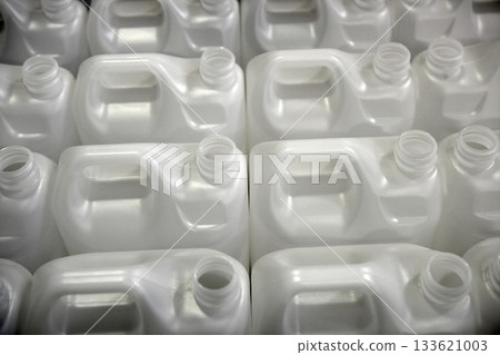 Bottles in factory rows, white plastic Bottles in factory rows, white plastic 133621003