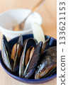 Vertical composition of mussels appetizer with lemon 133621153