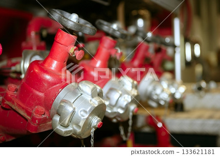 fire truck hose faucets in a row 133621181