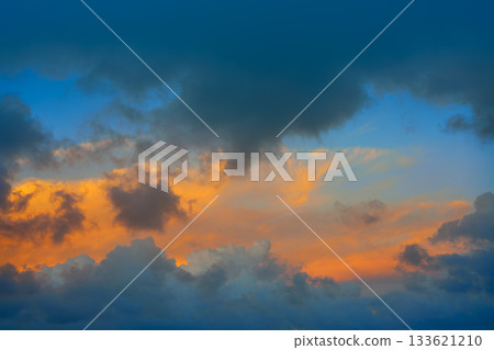 Dramatic clouds at sunset orange sky 133621210