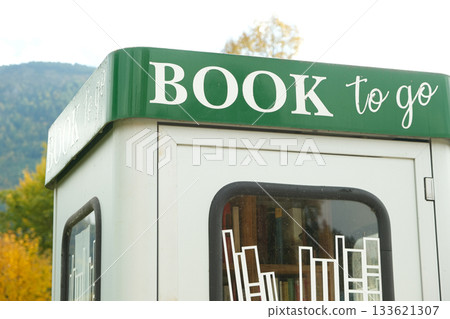 Book to go. Public street book-sharing kiosk with free community books for readers Book to go. Public street book-sharing kiosk with free community books for readers 133621307
