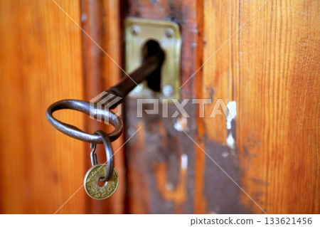 Old door woth rusted key, pesetas coin 133621456
