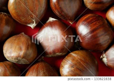 Chestnuts macro over red studio background 133621638