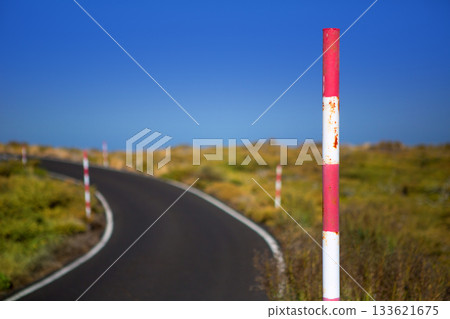 Snow road poles in high mountain blue sky Snow road poles in high mountain blue sky 133621675