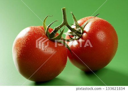 Red tomato macro over green background Red tomato macro over green background 133621834