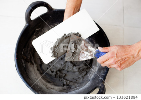 contruction mason worker hands with cement mortar 133621884