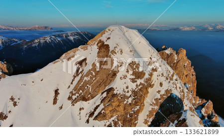 Rocky snow mountains at sunrise aerial Rocky snow mountains at sunrise aerial 133621899