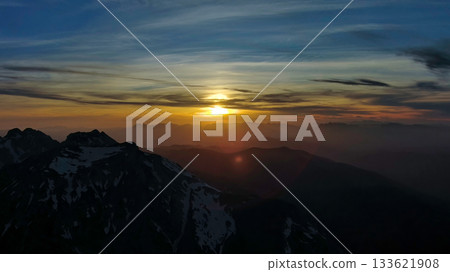 Rocky snow mountains at sunset aerial Rocky snow mountains at sunset aerial 133621908