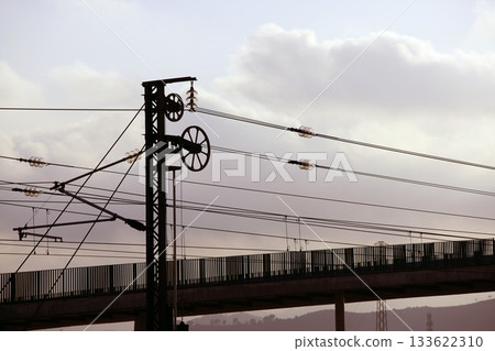 Cables and pole tower electric train railway 133622310