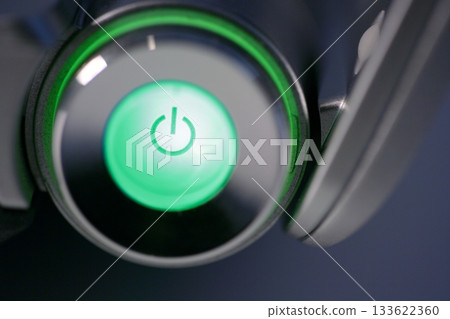 Green computer power on glowing button Green computer power on glowing button 133622360