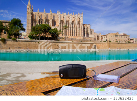 Car rental keys on wood table with city tourist map 133622425