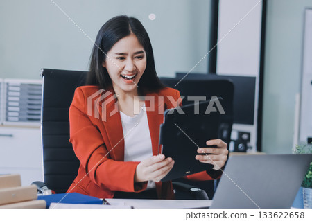 Beautiful young woman working using touchpad tablet 133622658