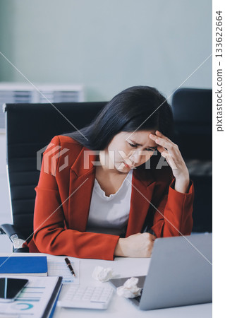 tired business woman sleepy and bored from sitting at a desk for a long time and has office syndrome 133622664