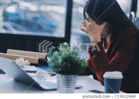 tired business woman sleepy and bored from sitting at a desk for a long time and has office syndrome tired business woman sleepy and bored from sitting at a desk for a long time and has office syndrome 133622666