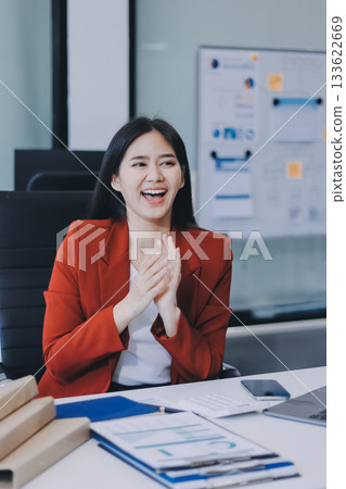 Asian business woman working on a laptop in a professional office 133622669