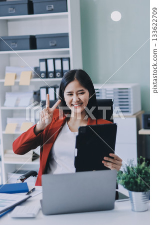 Beautiful young woman working using touchpad tablet 133622709