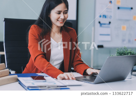 Asian business woman working on a laptop in a professional office 133622717