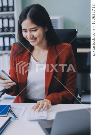 Asian business woman working on a laptop in a professional office 133622718