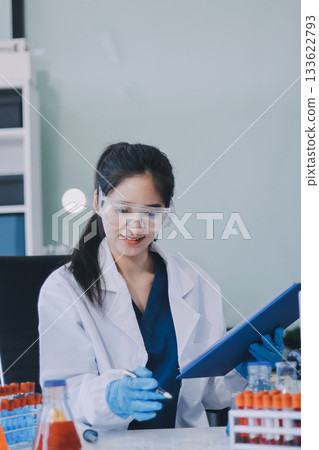 Portrait, science and happy woman on laptop in lab to research chemistry, test or innovation. Microscope, scientist and face of medical doctor in goggles for microbiology, healthcare or pharma study 133622793
