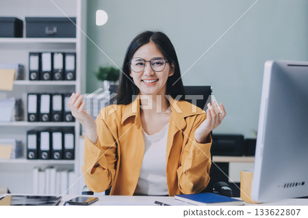 Business woman using calculator for do math finance on wooden desk in office and business working background, tax, accounting, statistics and analytic research concept. 133622807