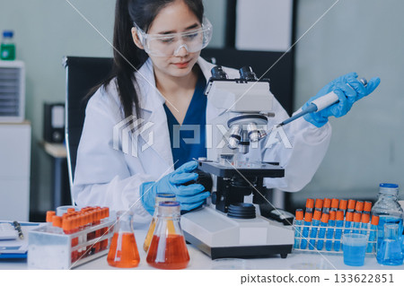 Portrait, science and happy woman on laptop in lab to research chemistry, test or innovation. Microscope, scientist and face of medical doctor in goggles for microbiology, healthcare or pharma study Portrait, science and happy woman on laptop in lab to research chemistry, test or innovation. Microscope, scientist and face of medical doctor in goggles for microbiology, healthcare or pharma study 133622851